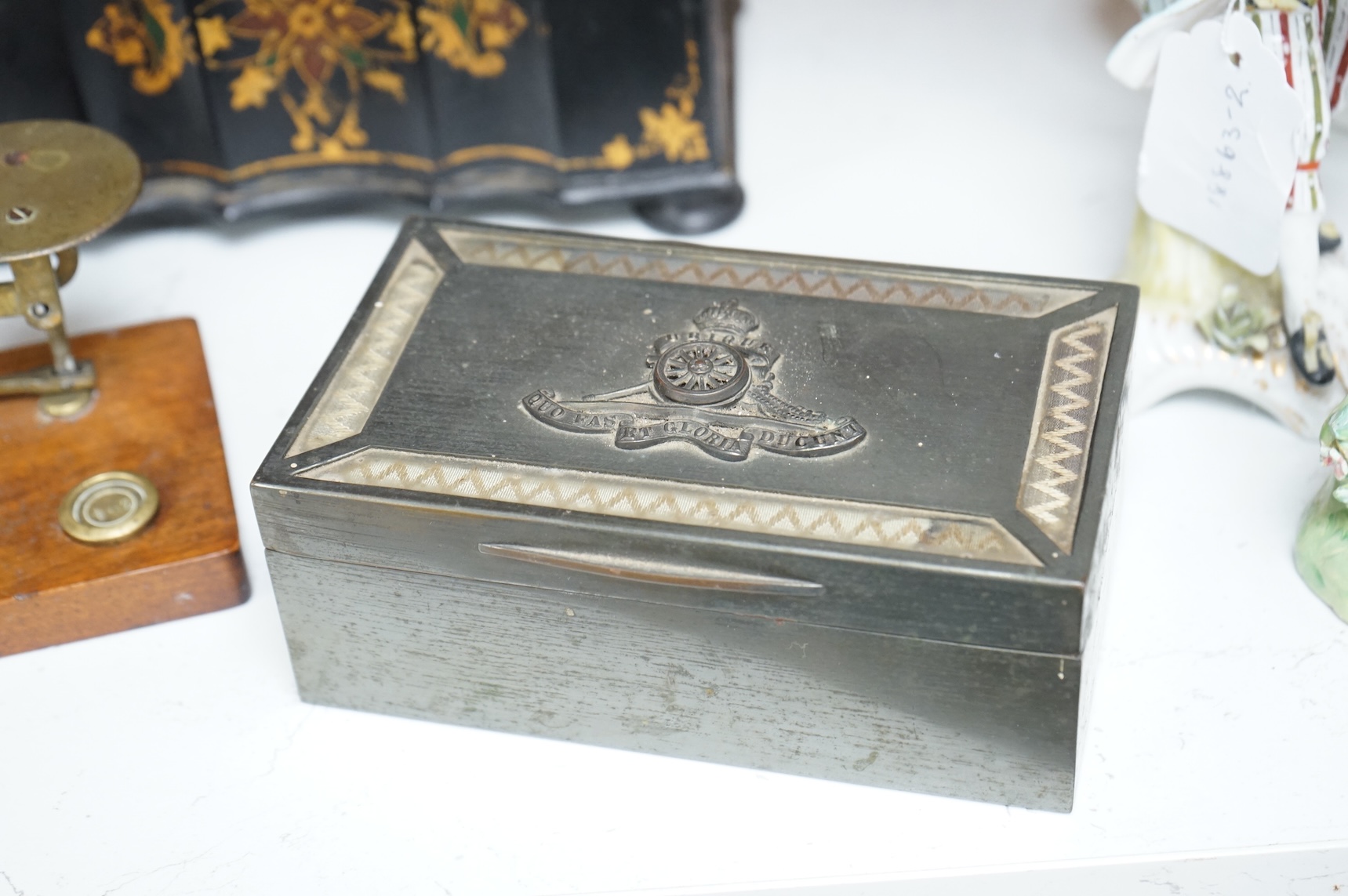 A Victorian papier maché tea caddy, postal scales and a military interest cigarette box, largest 19cm wide